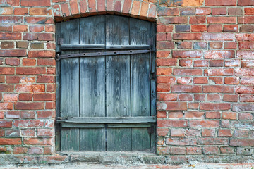 old gray Windows boarded up with planks basement