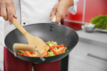 Mixing vegetables in pan closeup
