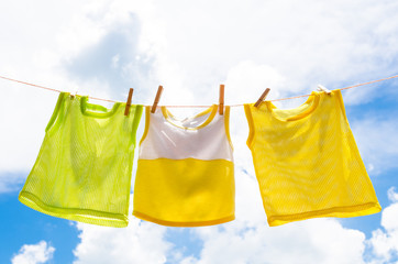 Baby clothes laundry hanging on the clotheline for sun dry after