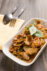 Close up stir fried clams in spicy source with glass of beer. Sp