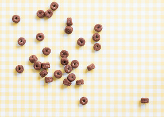 Chocolate cereal on yellow pattern background. Side light