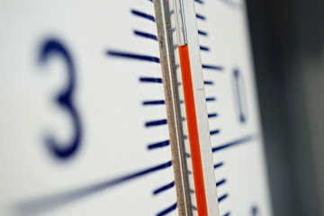 Macro detail of and old dusty outdoor thermometer in the retro design measuring very high temperature of thirty five degrees of Celsius as a symbol of summer and heat  - obrazy, fototapety, plakaty