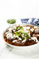 Meatballs in tomato sauce with feta cheese
