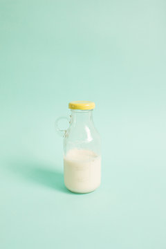 A bottle of milk on blue background.