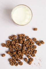 Top view of chocolate cereal with milk on blue background.