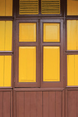 old wooden style windows with mustard yellow painted color