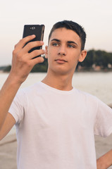 Teenager posing and taking a selfie.
