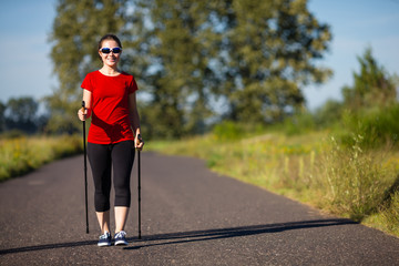 Nordic walking - active people working out in park 