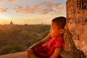 Monk relax on ancient temple in during sunset,Bagan Myanmar