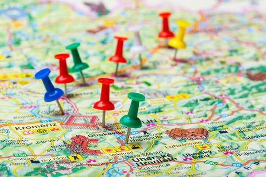 Travel destination points on a map indicated with colorful thumbtacks