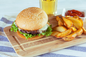 burger and french fries on wooden table
