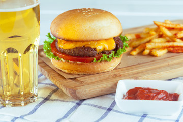 burger and french fries on wooden table