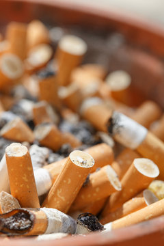 Big pile of put out cigarettes in an ashtray