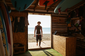 Surfer entering surf shack