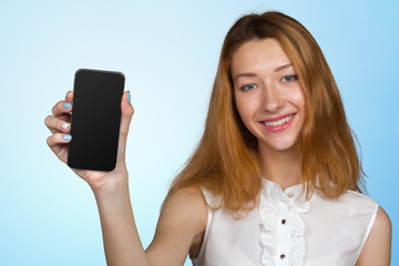 Smiling young woman showing blank smartphone screen