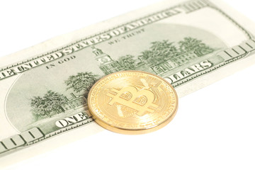 Golden bitcoin coin and one hundred dollar banknote isolated on