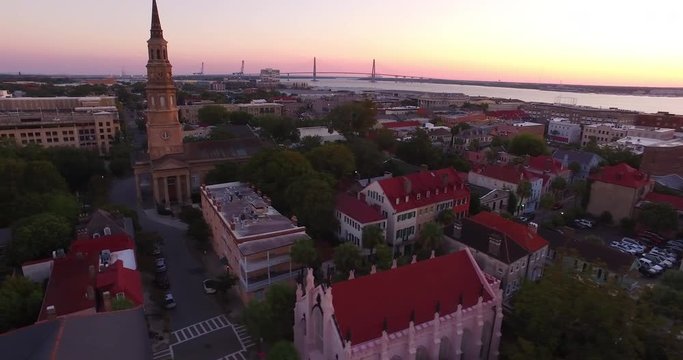 Aerial perspective of the St. Philip&rsquo;s Episcopal Church and French Huguenot Church in downtown Charleston, SC, as well as the Arthur Ravenel Jr. Bridge.