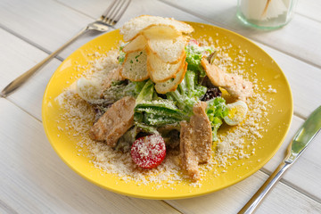 Restaurant food closeup. Caesar chicken salad with parmesan