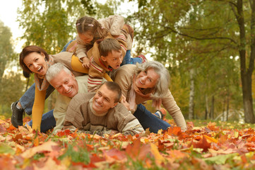Family relaxing in autumn park