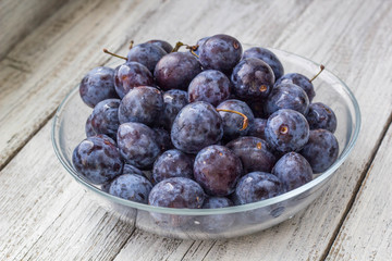 Fresh plums in cup