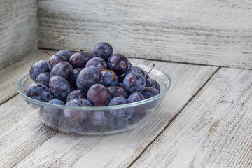 Fresh plums in cup