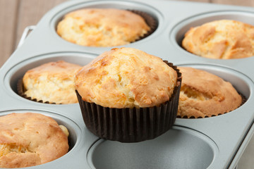 Homemade Cheddar Muffins In Baking Tray. Wooden Table.