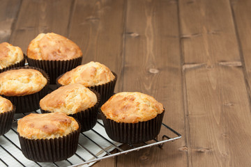 Homemade Cheddar Muffins In Paper Cases. Wooden Table.