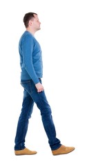 Back view of going  handsome man in blue pullover. walking young guy . Rear view people collection.  backside view of person.  Isolated over white background.