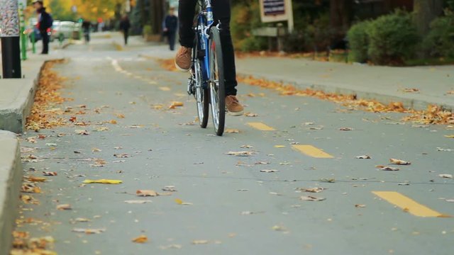 Selective Focus of Bike Path and People Bicycling in Autumn