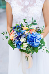 Bride holding blue wedding bouquet