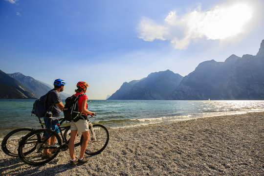 Mountain biking. Couple with bikes on Lake Garda, Riva del Garda