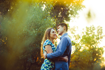 Fototapeta premium Loving couple embracing sitting in the woods.