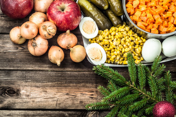 Vegetables for christmas salad on wooden table.