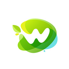 Letter W logo at green watercolor splash background.