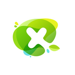 Letter X logo at green watercolor splash background.