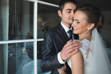 groom embracing his future  young wife