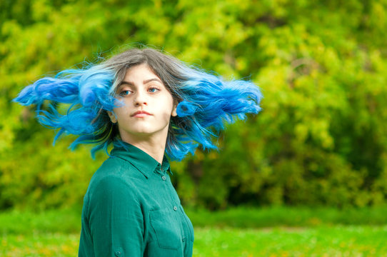 Young girl with streaming blue hair