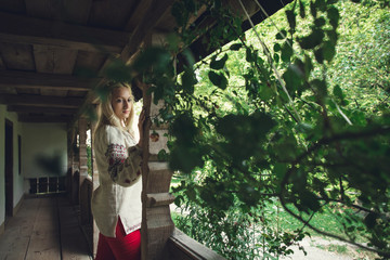 cute girl standing on the porch of his house
