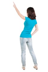 Back view of  pointing woman. beautiful brunette  girl in jeans. Rear view people collection.  backside view of person.  Isolated over white background.