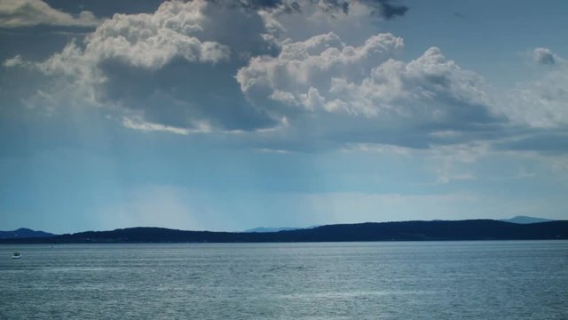 Big Cloud Timelapse in motion over Ocean with Boats Passing by
