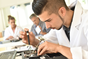 Student in technology fixing computer processing