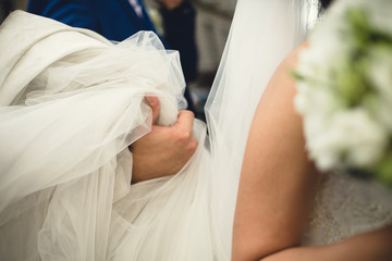 bride holding her white dress