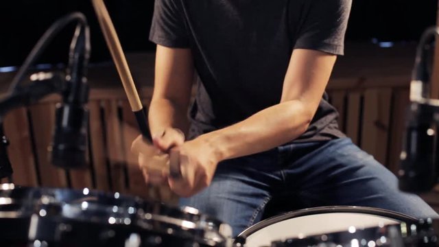 male musician playing drums and cymbals at concert