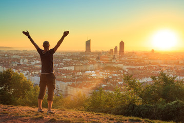 Man celebrating a new day in the city of Lyon, France.