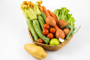 Different vegetables in the basket isolated white background / vegetables in a basket isolated on white