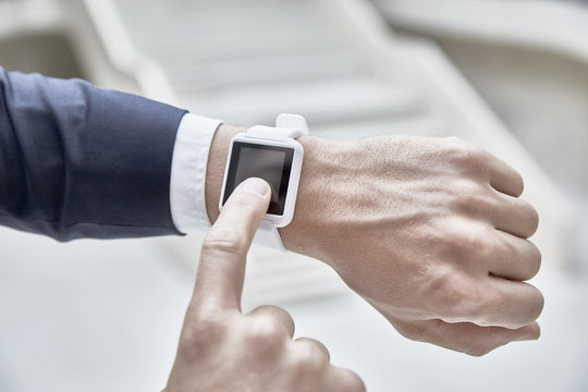 Businessman touching smartwatch