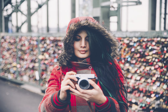 Germany, Cologne, woman with camera at Hohenzollern Bridge