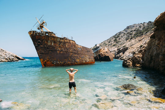 Greece, Cyclades Islands, Amorgos, Man at the beach, visiting a shipwreck, Olympia