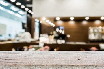 Wood table top on blur cafe restaurant with bokeh background