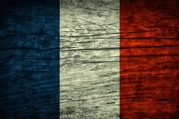 Vintage flag of France on a wooden surface